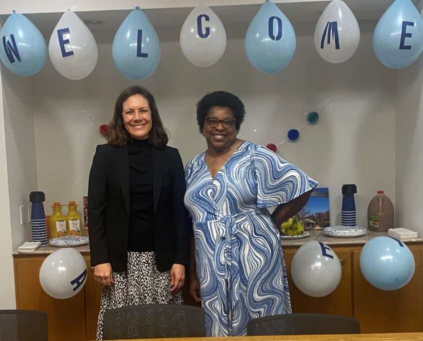 Ashley, a white woman with brown hair, is pictured with Pamela, a Black woman with black hair in the Raleigh office.