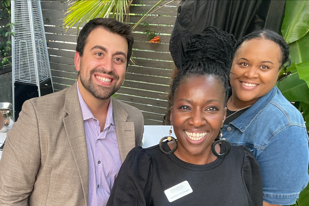 Lakisha, center, pictured at the North Carolina Bar Association Member Social following the October 2023 Board of Governors meeting. She is dressed in a black blouse and stands smiling with two fellow members.